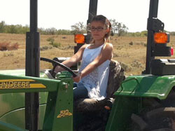 Whitney on a tractor